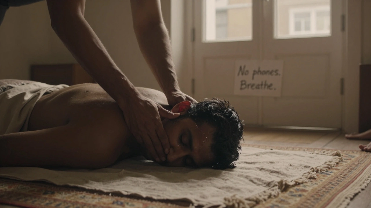 A man lying on a massage table in a quiet London attic, tears on his face as warm oil is applied to his scalp by a calm therapist.